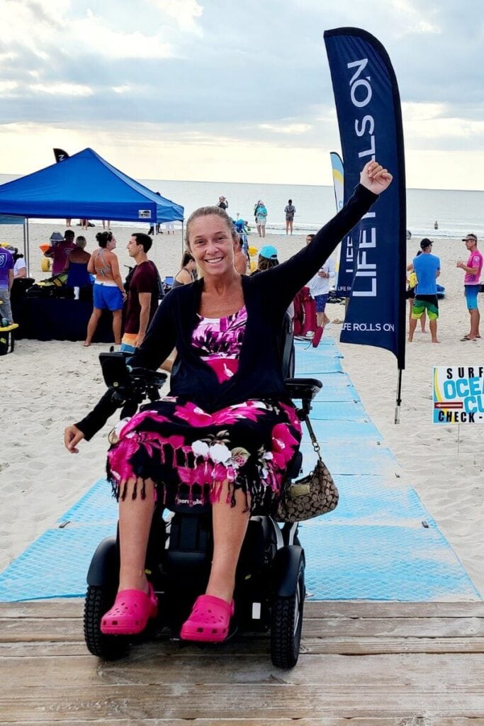 Ali Ingersoll embracing life by exploring the beach in her wheelchair